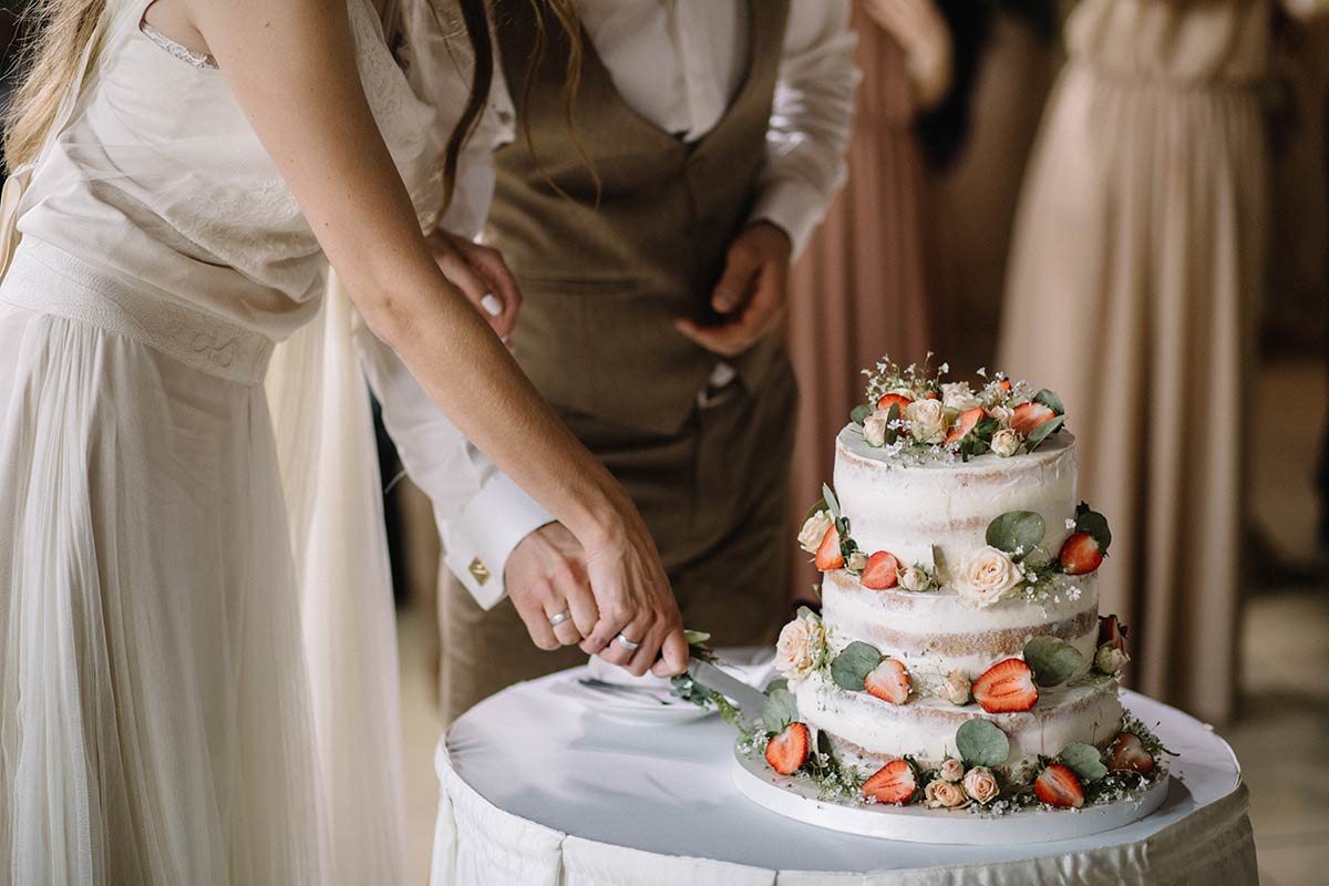 bride and groom cutting the cake