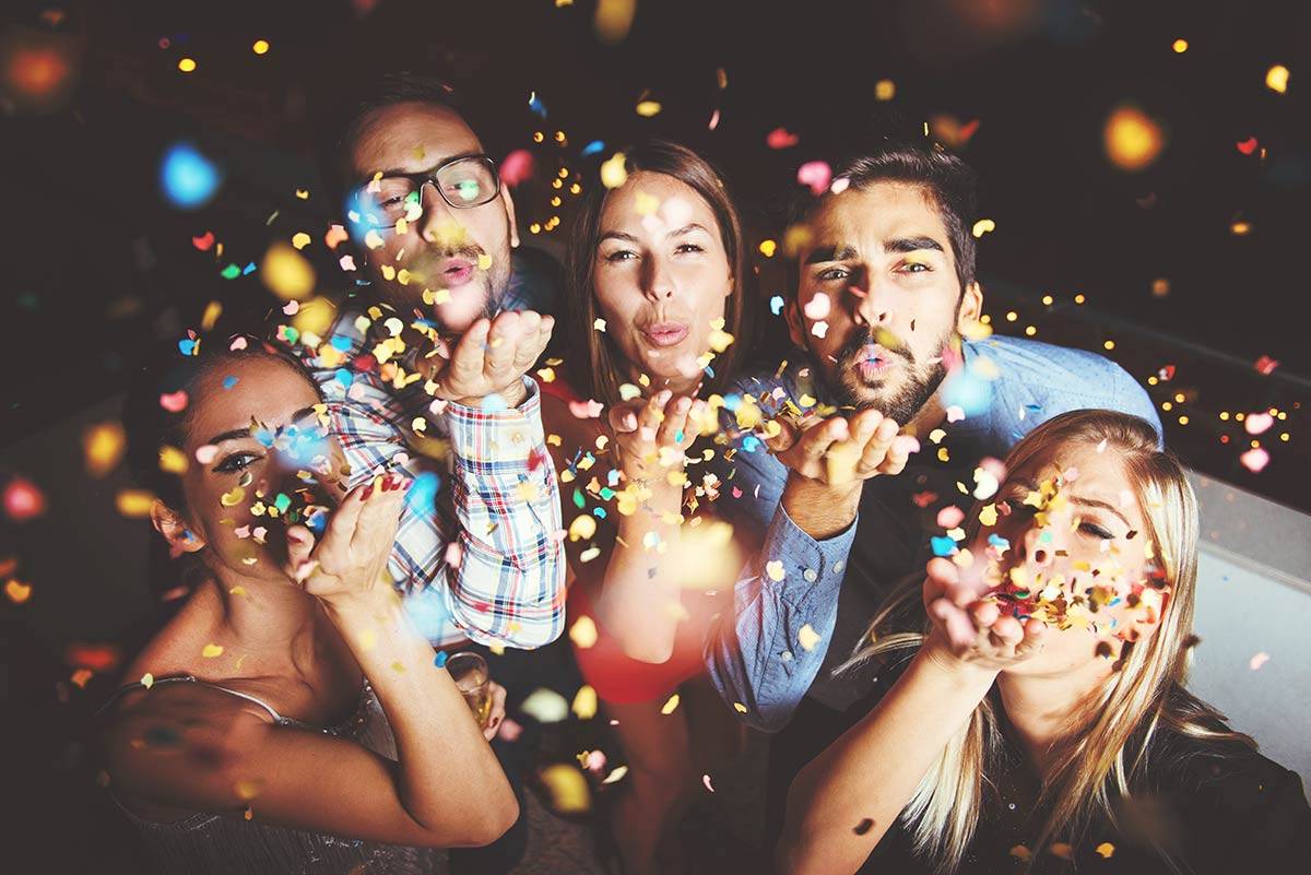 young women celebrating in bikini party, joyful female friends having a  party at home with flags colorful Stock Photo