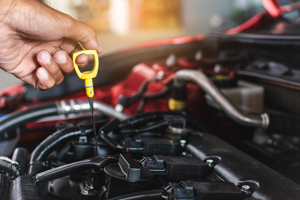 Man checking engine oil