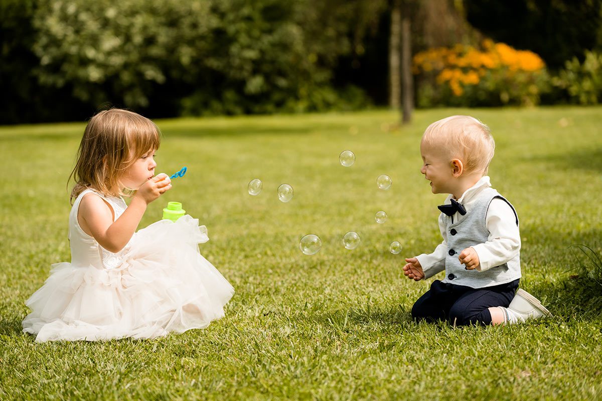 kids blowing bubbles at wedding